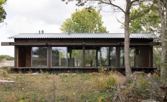 House Tjurpannan with Tar-Coated Black Timber Exterior by HelgessonGonzaga