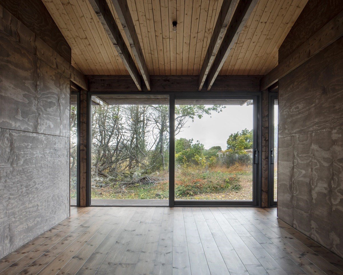 House Tjurpannan with Tar-Coated Black Timber Exterior by HelgessonGonzaga