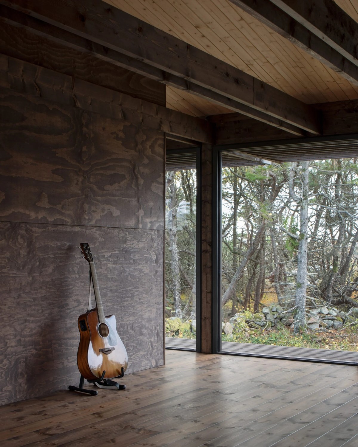 House Tjurpannan with Tar-Coated Black Timber Exterior by HelgessonGonzaga